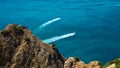 Seascape panorama. Summer vacation. Traveling. Virgin nature. Yacht trails on ocean. Deep blue water. Magnificent cliff Royalty Free Stock Photo