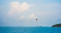 seascape with parasailing and boat under blue sky