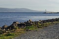 Seascape of pier with cross at end for fishing boat in the Black Sea and Balkan mountain with Cape Emine near ancient Nessebar Royalty Free Stock Photo