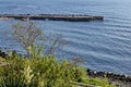 Seascape of pier for fishing boat with coastal road in the Black Sea and small beach near ancient city Nessebar Royalty Free Stock Photo