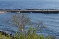 Seascape of pier for fishing boat with coastal road in the Black Sea and small beach near ancient city Nessebar Royalty Free Stock Photo