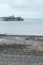 A seascape with a pier and a pebble beach in Llandudno north Wales