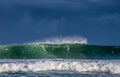 Seascape. Powerful ocean wave on the surface of the ocean. Wave breaks on a shallow bank. Royalty Free Stock Photo