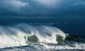 Seascape. Powerful ocean wave on the surface of the ocean. Wave breaks on a shallow bank. Stormy weather, clouds sky. Royalty Free Stock Photo