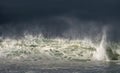 Seascape. Powerful ocean wave on the surface of the ocean. Wave breaks on a shallow bank. Stormy weather, stormy clouds sky Royalty Free Stock Photo