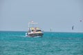 Seascape with ripple surface of blue sea water with white speedboat on anchor floating on calm waves