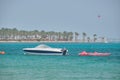 Seascape with ripple surface of blue sea water with white speedboat on anchor floating on calm waves