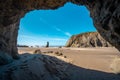 Seascape of rock stacks and beach from a cave