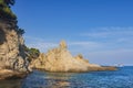 Seascape with a rocky shore in a clear sunny day. Large rocks in the sea near the coastline. Nature of Costa Brava, Spain.