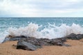 Seascape with rocky stones and splashes in the foreground Royalty Free Stock Photo