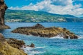 Rocks in turquoise sea with coastline of SÃ£o Miguel island in the background, Azores PORTUGAL Royalty Free Stock Photo