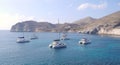 Seascape with sailboat, catamarans, sailing yachts near Red Beach. Santorini, Greece.