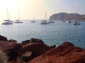 Seascape with sailboat, catamarans, sailing yachts near Red Beach. Santorini, Greece.