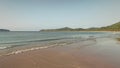 Seascape at sand beach of mountain island aerial. Waves wash sandy ocean shore. Sea bay with forest Royalty Free Stock Photo