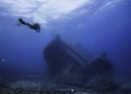 Seascape of a scuba diver approaching a ship wreck Royalty Free Stock Photo