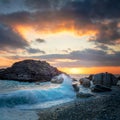 Seascape. Sea Ocean Wave hit the rock at beach, sea water splash up to the sky with sun. Sunset Sundown at Sea. Storm Royalty Free Stock Photo