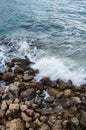 Seascape, seafoam of storm on wild rocky seashore