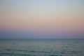 Seascape with seagull over water. Sunset over the sea. Calm evening on island beach. Tranquility concept. Dramatic evening sky.