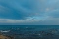 Seascape from the shore with views of the cliffs on the ocean and the blue sky with clouds. Horizon of the ocean. Beautiful nature Royalty Free Stock Photo