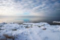 Seascape, slow freezing sea, glorious skies, white pieces of ice by the sea