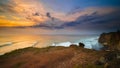 Seascape. Spectacular view from Uluwatu cliff in Bali. Sunset time. Blue hour. Ocean with motion foam waves. Cloudy sky. Nature Royalty Free Stock Photo