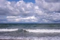 Seascape with storm sea waves with foam under heavy cumulonimbus on the sky to horizon Royalty Free Stock Photo