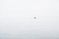 Seascape in the style of minimalism. Small fishing boat is minimal far in the blue sea between sky and water Royalty Free Stock Photo