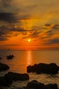 Seascape with The Sun, Sunrays, Rocks, Clouds and Sky at Sunrise