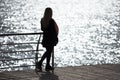 Girl contemplate the sunlight glare in the sea