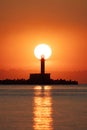 Seascape of sunrise over sea lighthouse and coastal beach shore, vertical view of seascape Royalty Free Stock Photo