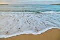 Seascape at sunrise, sea background, foam, sand, dawn. Royalty Free Stock Photo