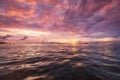 Seascape during the sunrise. Sky and reflections on the water in the summer. Sun rays during the sunrise. Nusa Penida, Bali, Indon