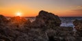 Seascape sunset with rock formation on the foreground