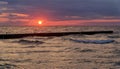 Seascape at sunset in stormy weather. Waves on the sea and dark clouds in the sky. Baltic Sea, Western Pomerania, Poland, Europe Royalty Free Stock Photo