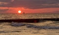 Seascape at sunset in stormy weather. Waves on the sea and dark clouds in the sky. Baltic Sea, Western Pomerania, Poland, Europe Royalty Free Stock Photo