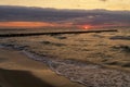 Seascape at sunset in stormy weather. Waves on the sea and dark clouds in the sky. Baltic Sea, Western Pomerania, Poland, Europe Royalty Free Stock Photo