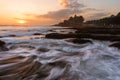 Seascape in sunset with strong wave at Tanah Lot Temple in Bali, Indonesia. Famous landmark tourist attraction and travel destinat