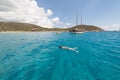 Seascape with swimming woman and some boats turquoise sea of Mari Pintau - Sardinia - Italy