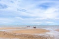 Seascape in Thailand with fishing boats on low tide beach. Royalty Free Stock Photo