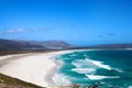 Seascape, turquoise ocean water waves, blue sky, white sand lonely beach panorama Chapmans Peak Drive road, South Africa coast t