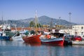 Seascape view of the old port with traditional fishing boats under blue sky, Volos, Greece