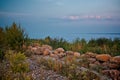 Seascape view. Rocky beach in evening. Pebble shore. Tinted photo Royalty Free Stock Photo