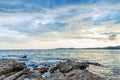 Seascape view with rocky coast and sea with mountain sky and couds before rain. Royalty Free Stock Photo