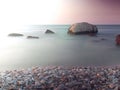 Seascape view with small stones on the beach purple cloudy sky background Royalty Free Stock Photo