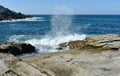 Seascape with waves breaking against the rocks and blue sky. Galicia, Spain. Royalty Free Stock Photo