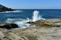 Seascape with waves breaking against the rocks and blue sky. Galicia, Spain. Royalty Free Stock Photo