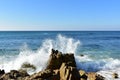 Seascape with waves breaking against the rocks and blue sky. Galicia, Spain. Royalty Free Stock Photo