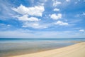 Seascape white sand beach with clear wave water and blue sky with white clouds