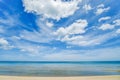 Seascape white sand beach with clear wave water and blue sky with white clouds