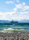 Seascape whith ship on mountains background
